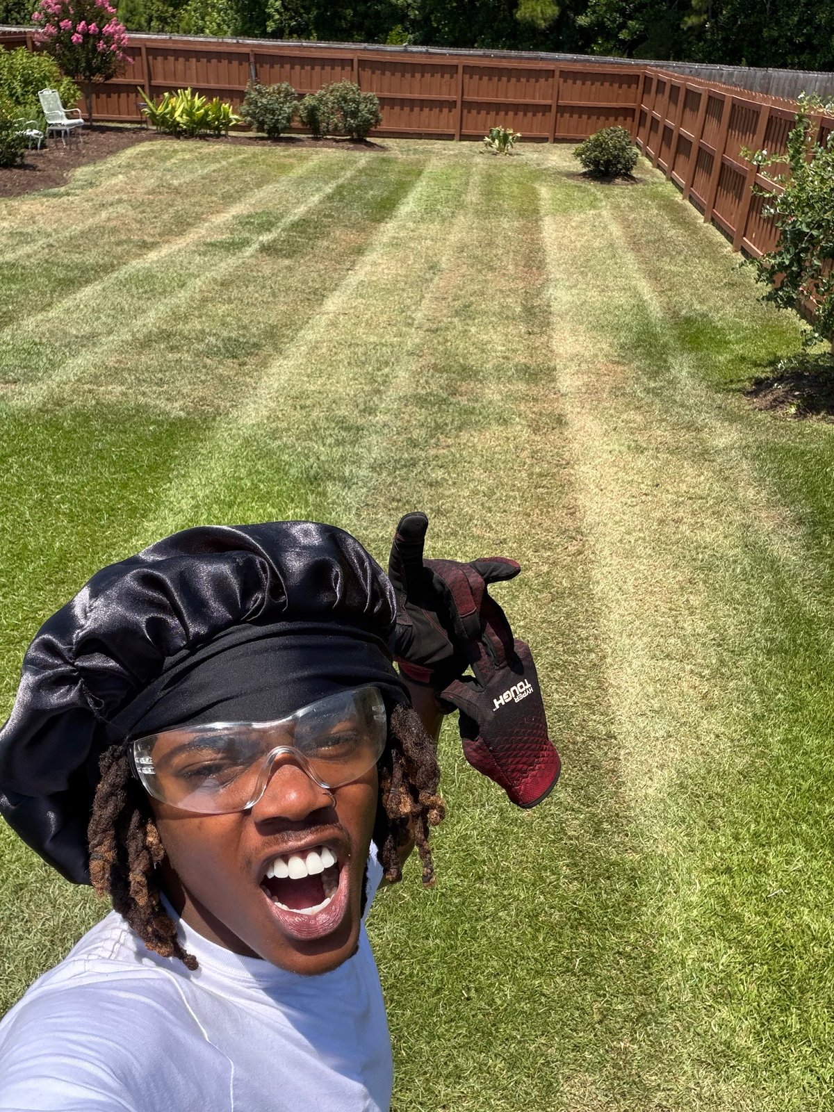 Alvin giving a thumbs up in a freshly striped backyard